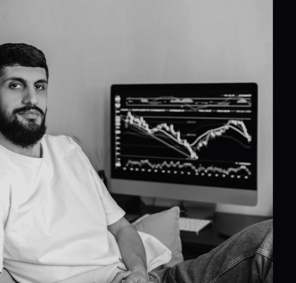 Broker working at a desk with a trading chart on screen
