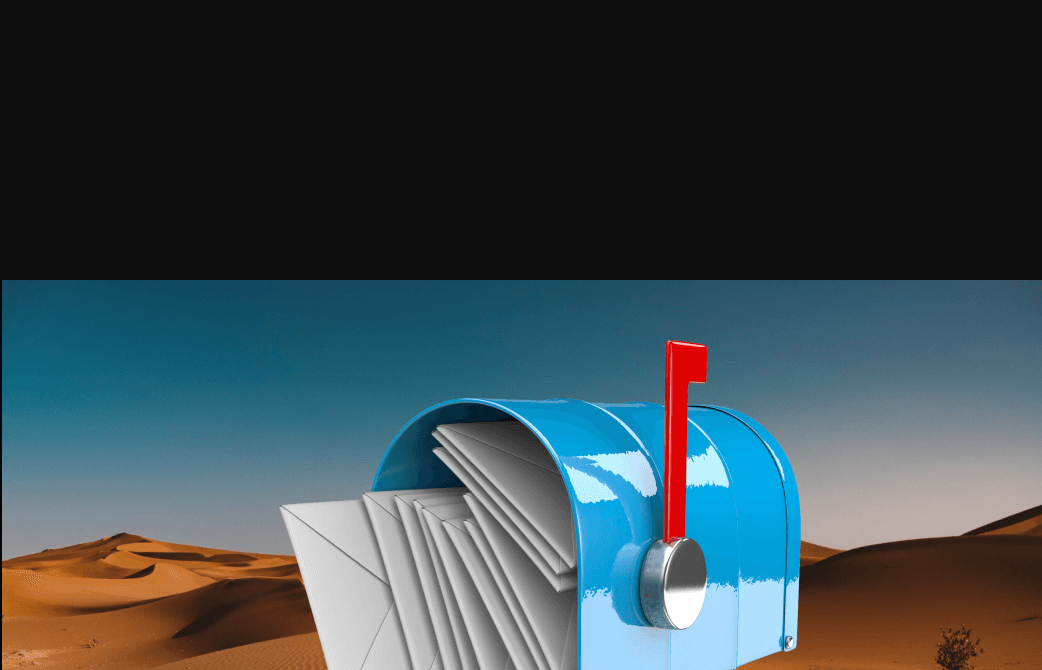 Blue mailbox full of letters in a desert
